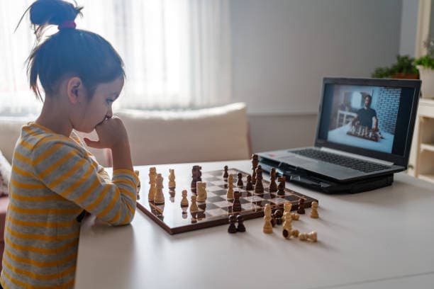 A focused child playing a game of chess